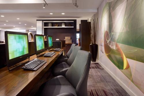 an office with a desk with four computers on it at Courtyard Milpitas Silicon Valley in Milpitas