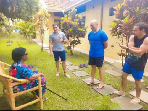a group of people standing in a yard at Tgs Homestay Nest in Kampala