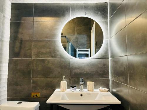a bathroom with a sink and a mirror at eliTe deluxe 1 in Kavala