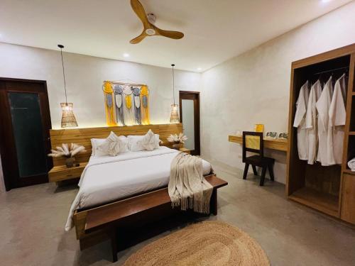 a bedroom with a large bed with a ceiling fan at Lio Villas Resort in El Nido
