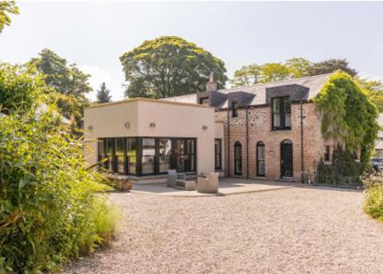 a large brick house with a driveway in front of it at The Barn, Walworth Demesne in Ballykelly