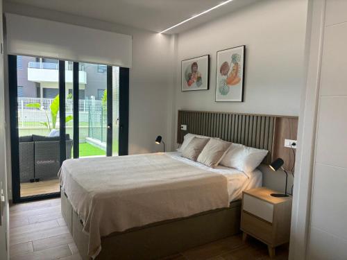 a bedroom with a large bed and a balcony at Cosy Casa Valentino in Orihuela Costa