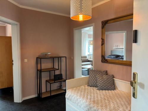 a bedroom with a bed and a mirror at Apartment im Elbtal Meißen-Dresden in Meißen