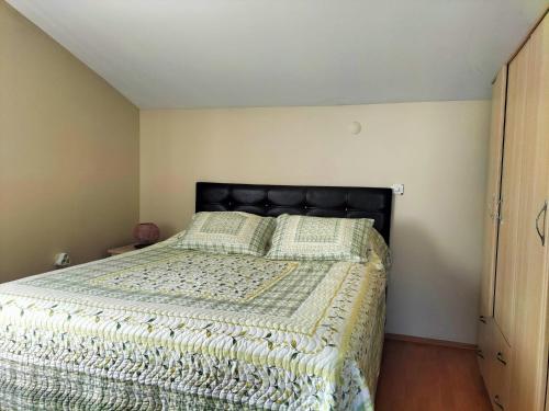 a bedroom with a bed with a black headboard at The Rooftop Urla in Urla