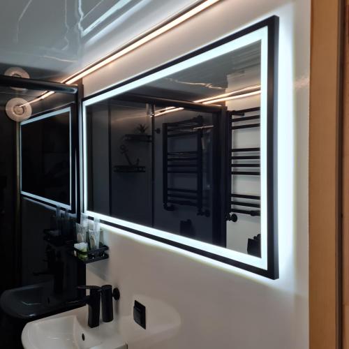 a bathroom with a mirror above a sink at Seezeit- Schwielochsee- Hausboot in Schwielochsee
