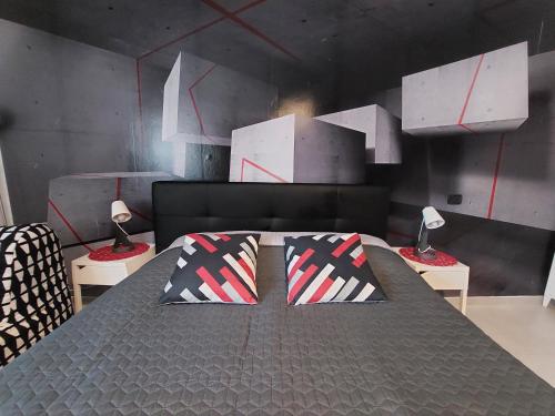 a bedroom with a bed with two pillows on it at B&B GoodDay Roma Tor Vergata in Tor Vergata