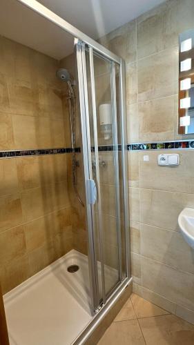 a bathroom with a shower and a sink at Hotel Muza in Košice
