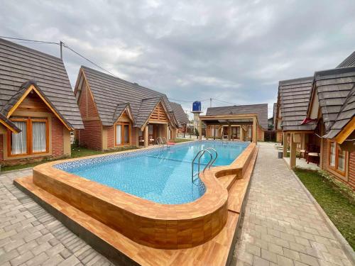 a swimming pool in front of some houses at Villa Andhita Pantai Garut in Mancagahar