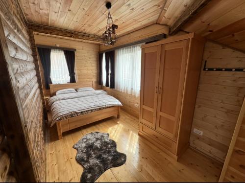 a bedroom in a log cabin with a bed at Zagrad Homes in Zabljak in Žabljak