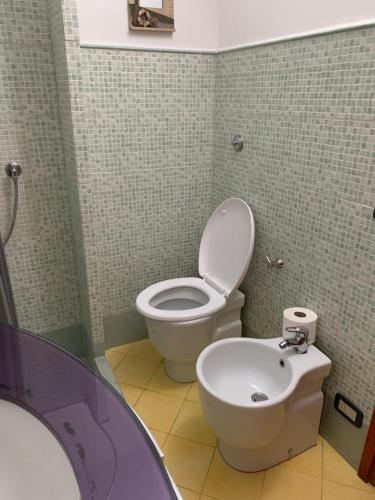 a bathroom with a toilet and a bidet at Affitti Liana in Lucca
