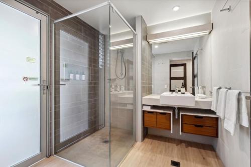 a bathroom with a shower and a sink at Panoramic Ocean Penthouse in Noosa Heads