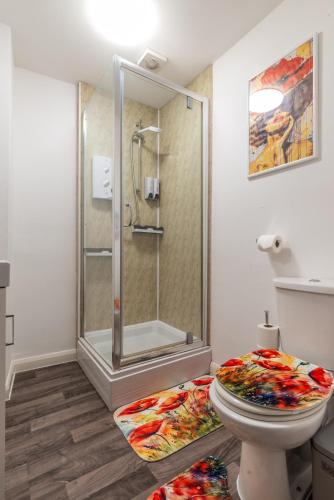 a bathroom with a shower and a toilet at Blossom Retreat in Northampton