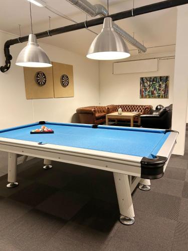 a pool table in a living room with a couch at athome apartments in Aarhus