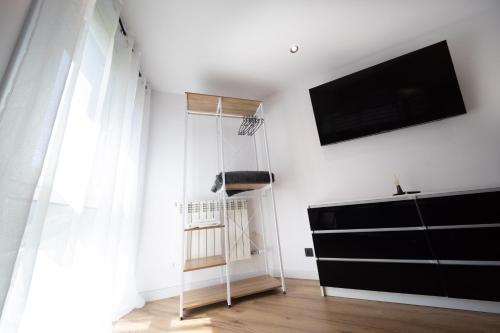 a living room with a tv and a black dresser at Piso Andorra Arinsal in Arinsal