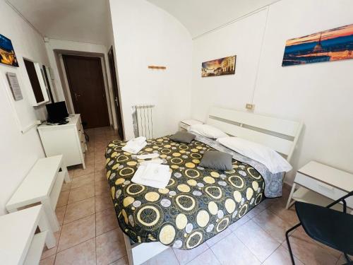 a small bedroom with a bed and a desk at B&B Da Lisa in Turin