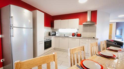 a kitchen with a table and chairs and a refrigerator at Grande maison en Ardèche in Chalencon