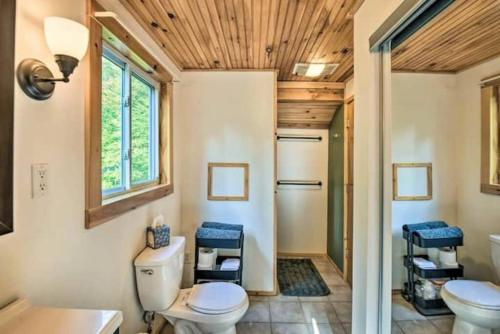 a bathroom with a toilet and a sink at Whispering Woods Cabin - Creekside & Pet Friendly in Grafton