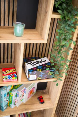 a wooden shelf with toy boxes on it at Piso Andorra Arinsal in Arinsal