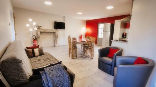 a living room with a couch and chairs and a table at Grande maison en Ardèche in Chalencon