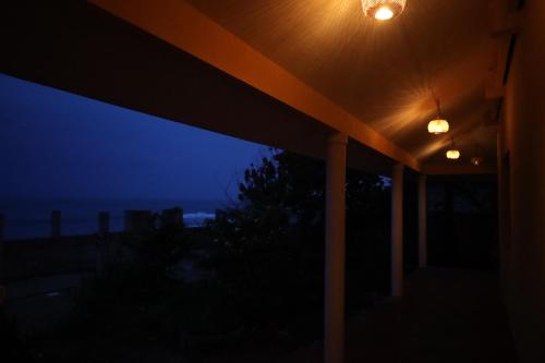 a view of the ocean at night from a house at Le Serene Independent Beach Villa in Kottakupam