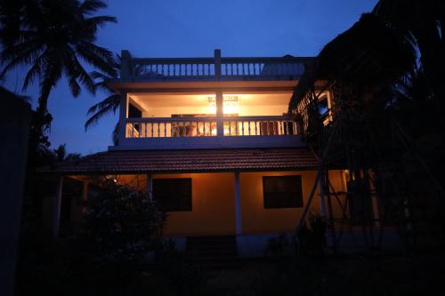 a house with the sun shining on the balcony at Le Serene Independent Beach Villa in Kottakupam