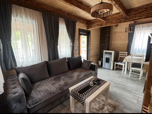 a living room with a couch and a table at Zagrad Homes in Zabljak in Žabljak