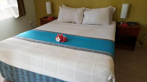 a bedroom with a bed with a flower on it at Hexagon International Hotel, Villas & Spa in Nadi