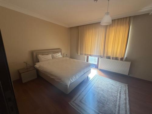 a bedroom with a white bed and a window at Corner splash in Ankara