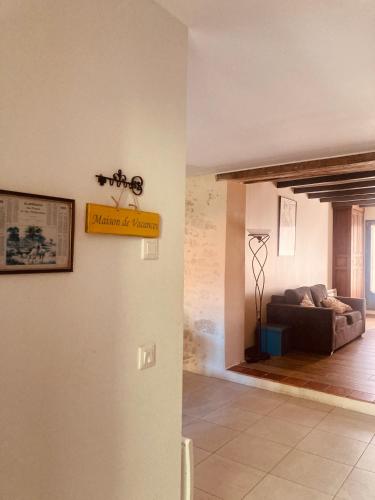 a living room with a sign on a wall at Maison avec jardin dans village in Réaup