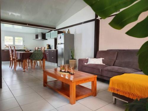 a living room with a couch and a table at Caz A Mwa in Saint-Joseph