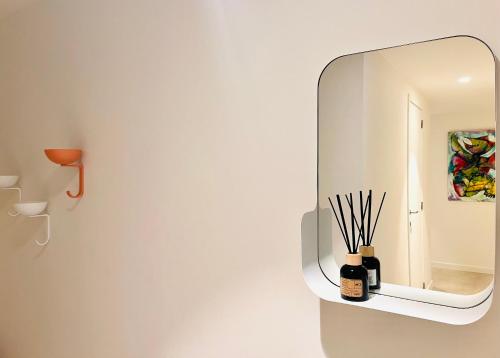 a mirror on a wall next to a wall at Villa Karmel modern 3 bedroom appartment in Blankenberge