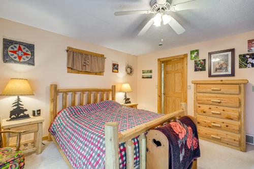 a bedroom with a bed and a ceiling fan at Near Beach Access Torch Lake Cabin Retreat! in Rapid City