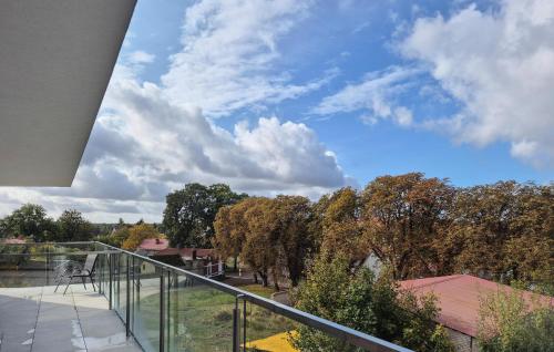a balcony with a view of trees and the sky at Beautiful Apartment In Insko With Sauna in Ińsko