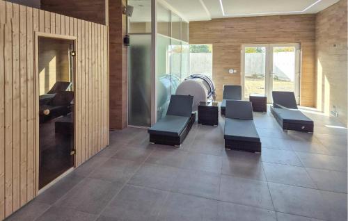 a waiting room with chairs and a table at Beautiful Apartment In Insko With Sauna in Ińsko