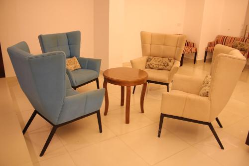 a group of chairs and a table in a room at La Vista Suites Sylhet in Sylhet
