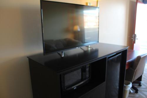 a flat screen tv sitting on top of a black cabinet at Tourway Inn in Birmingham