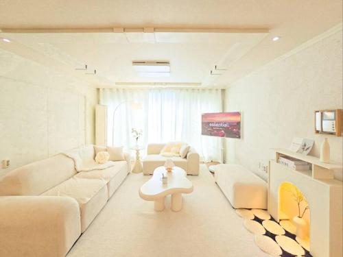 a living room with a couch and a table at Yeon Stay in Seoul