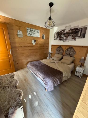 a bedroom with two beds and a wooden wall at Agora in Samoëns