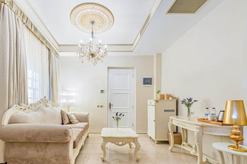 a living room with a couch and a table at Elegance East Hotel in Antalya