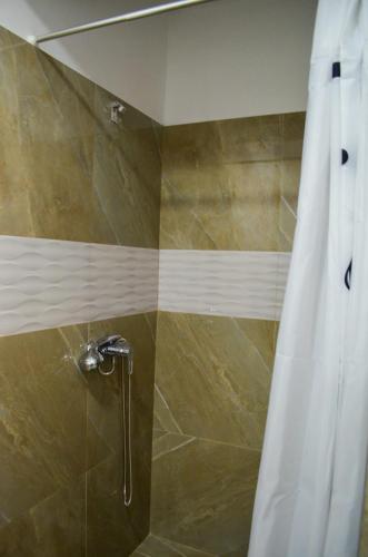 a shower with a white shower curtain in a bathroom at VIP next TIME Casa Vacanta in Costinesti