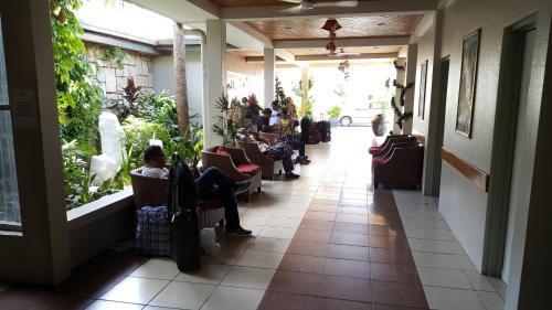 a group of people sitting in chairs in a building at Hexagon International Hotel, Villas & Spa in Nadi
