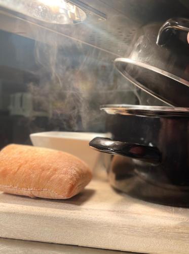 a loaf of bread sitting on a counter next to a pot at The Lilly Restaurant With Rooms in Llandudno