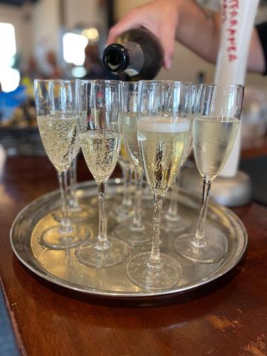 a tray filled with champagne glasses on a table at The Lilly Restaurant With Rooms in Llandudno