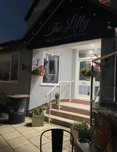 a restaurant with a sign on the front of it at The Lilly Restaurant With Rooms in Llandudno