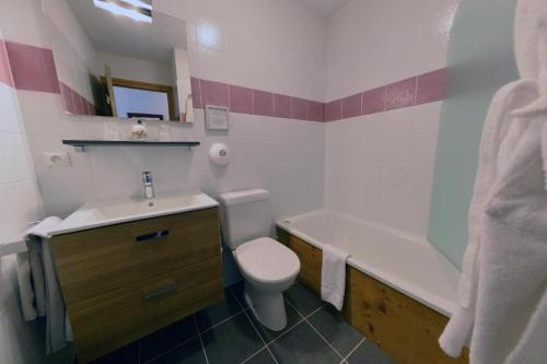 a bathroom with a sink and a toilet and a bath tub at Bellevue Guest House in Les Gets