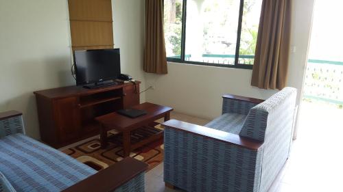A television and/or entertainment center at Hexagon International Hotel, Villas & Spa