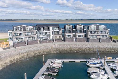 a group of buildings with boats in a marina at Vakantiewoning aan het water - met 2 balkons - Vista Maris - Nr 52 in Sint Annaland