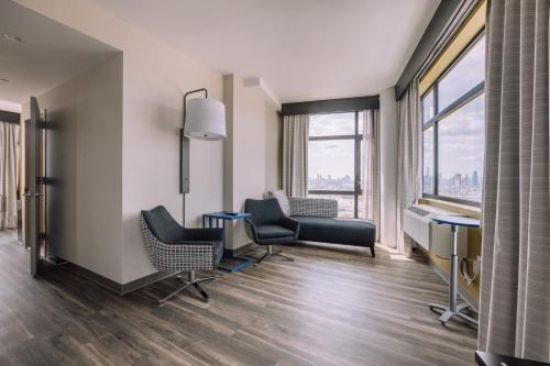 a waiting room at a hospital with chairs and a table at Holiday Inn Express Long Island City E - New York by IHG in Queens