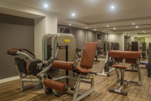 a gym with cardio equipment and chairs in a room at Flor Da Rocha in Portimão