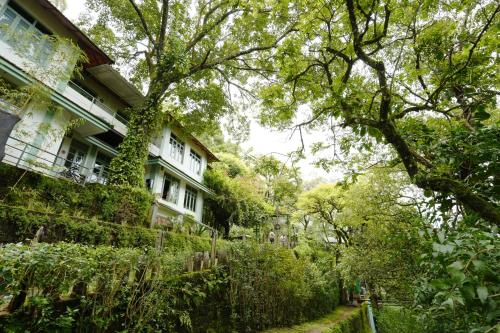 a building with ivy growing on the side of it at Blackberry Hills Munnar Nature Resort & Spa in Munnar